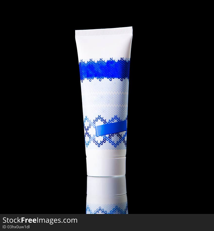 A tube of cream isolated on black background