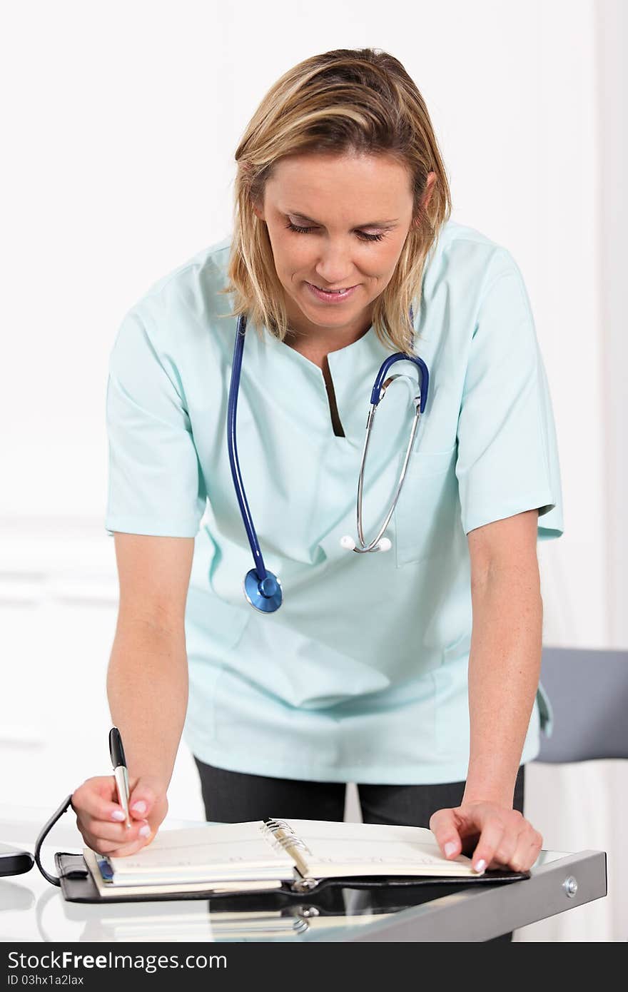 Woman doctor with pen and stethoscope. Woman doctor with pen and stethoscope