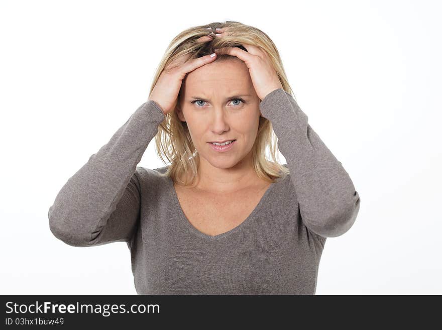 Beautiful blond woman in studio with head in the hands. Beautiful blond woman in studio with head in the hands