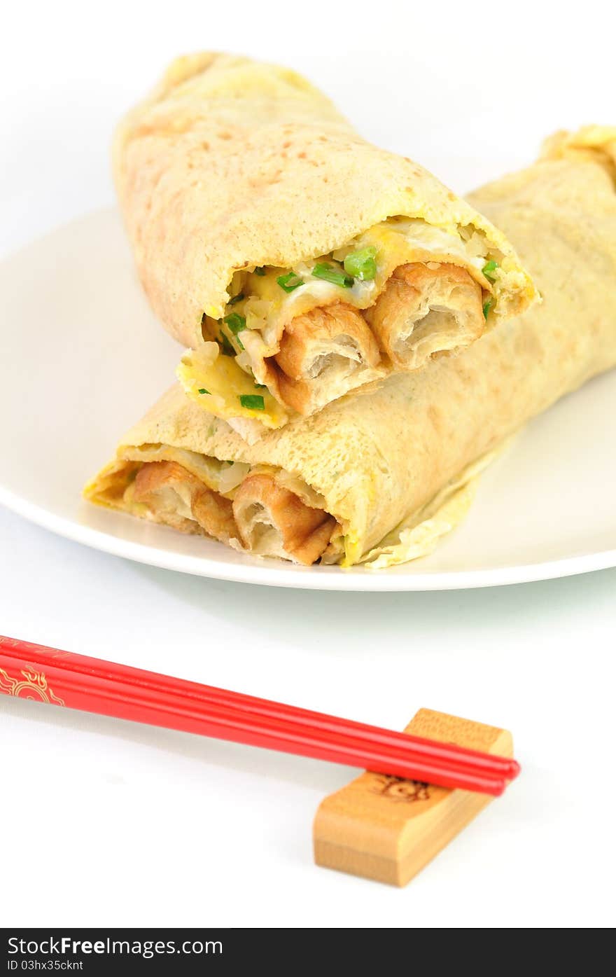 Traditional Chinese breakfast pancakes with red chopsticks. Traditional Chinese breakfast pancakes with red chopsticks.