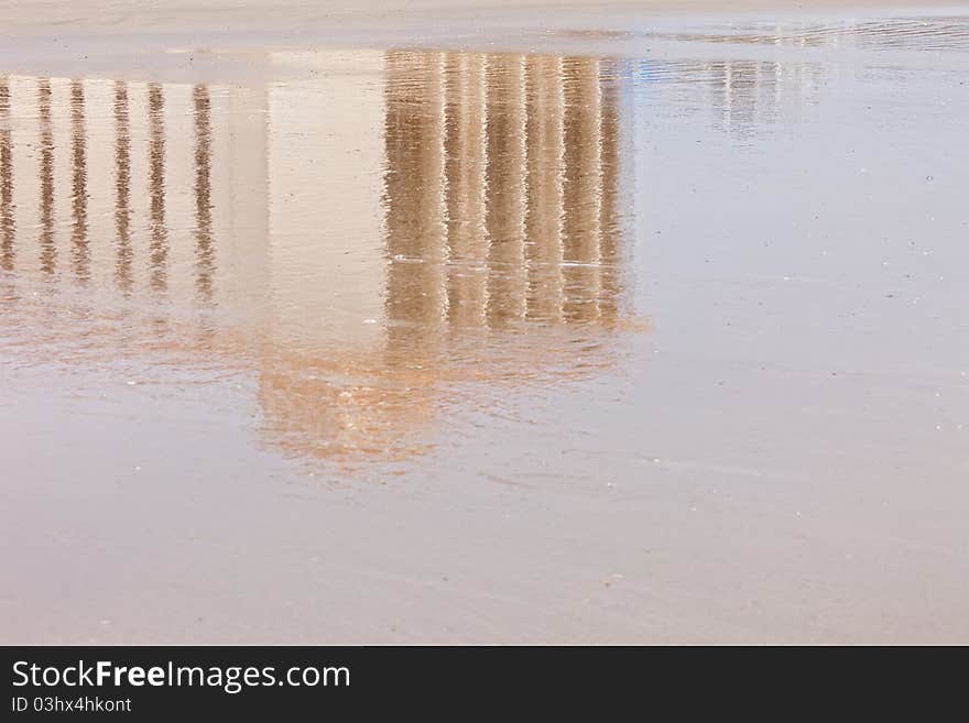 Reflection of building in wet sand on Florida Beach