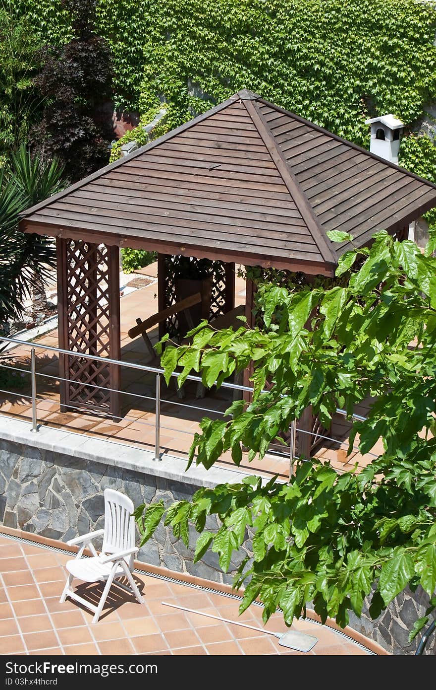 Wooden gazebo for grilling in a country house. Wooden gazebo for grilling in a country house