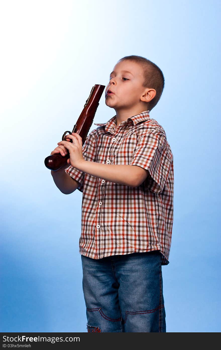 Cute boy playing with the gun