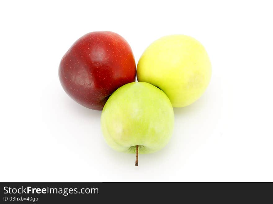 Three apples red, yellow, green on a white background