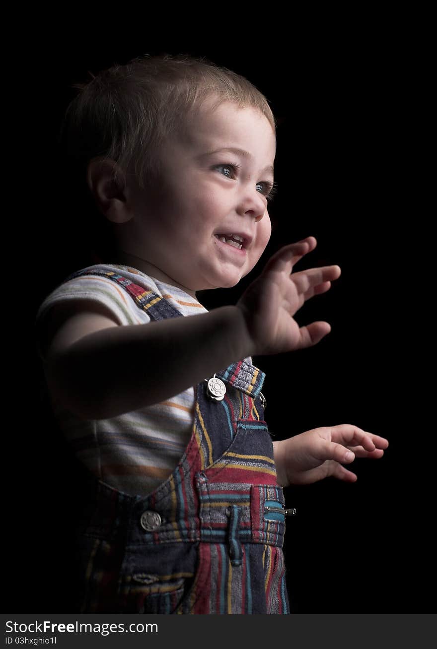 Little boy smiles in colorful pants