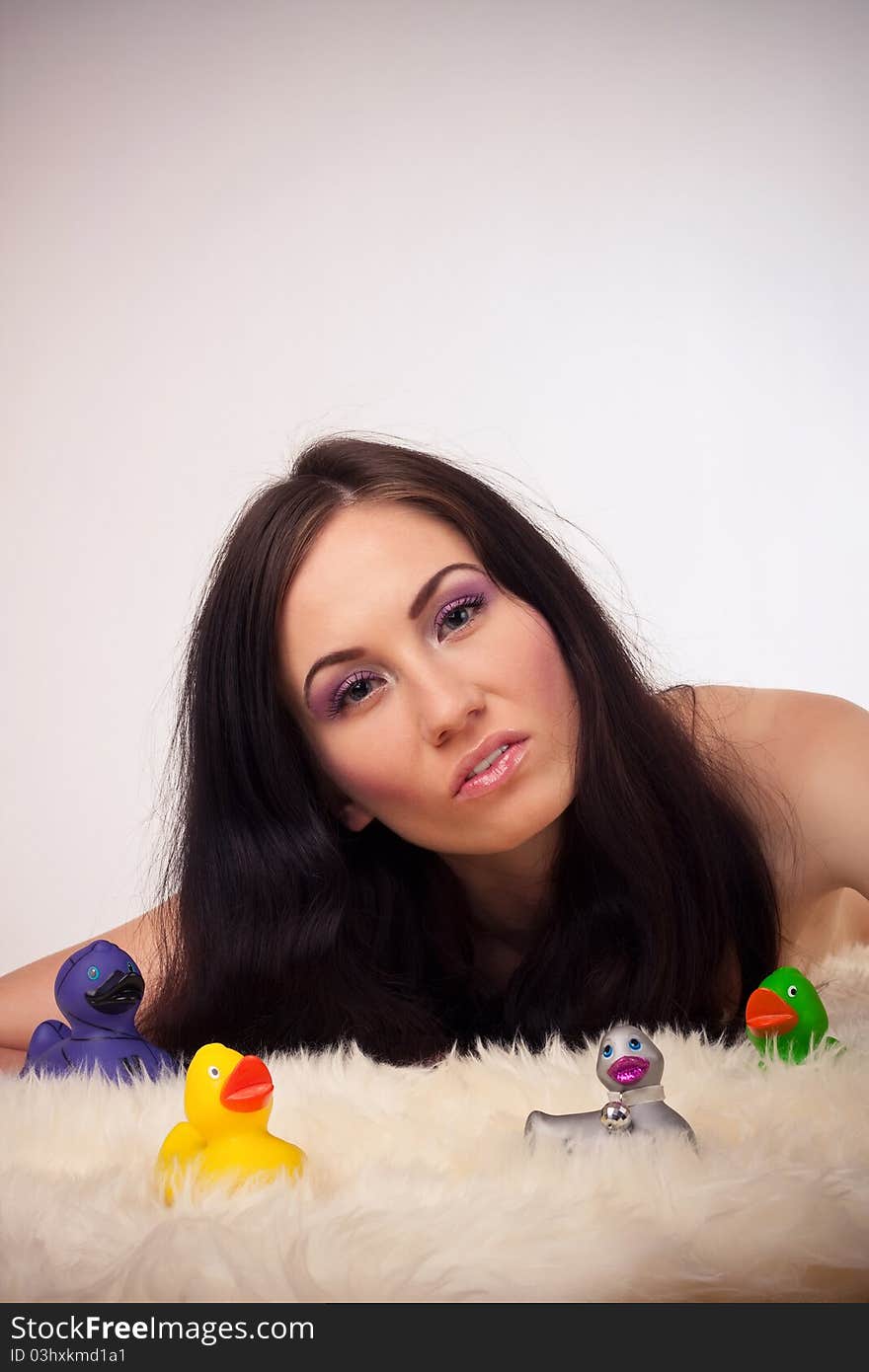 Funny girl portrait with colorful ducks toy