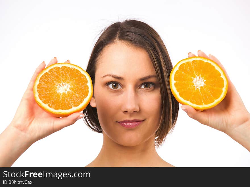 Young woman holding two halves of orange. Young woman holding two halves of orange