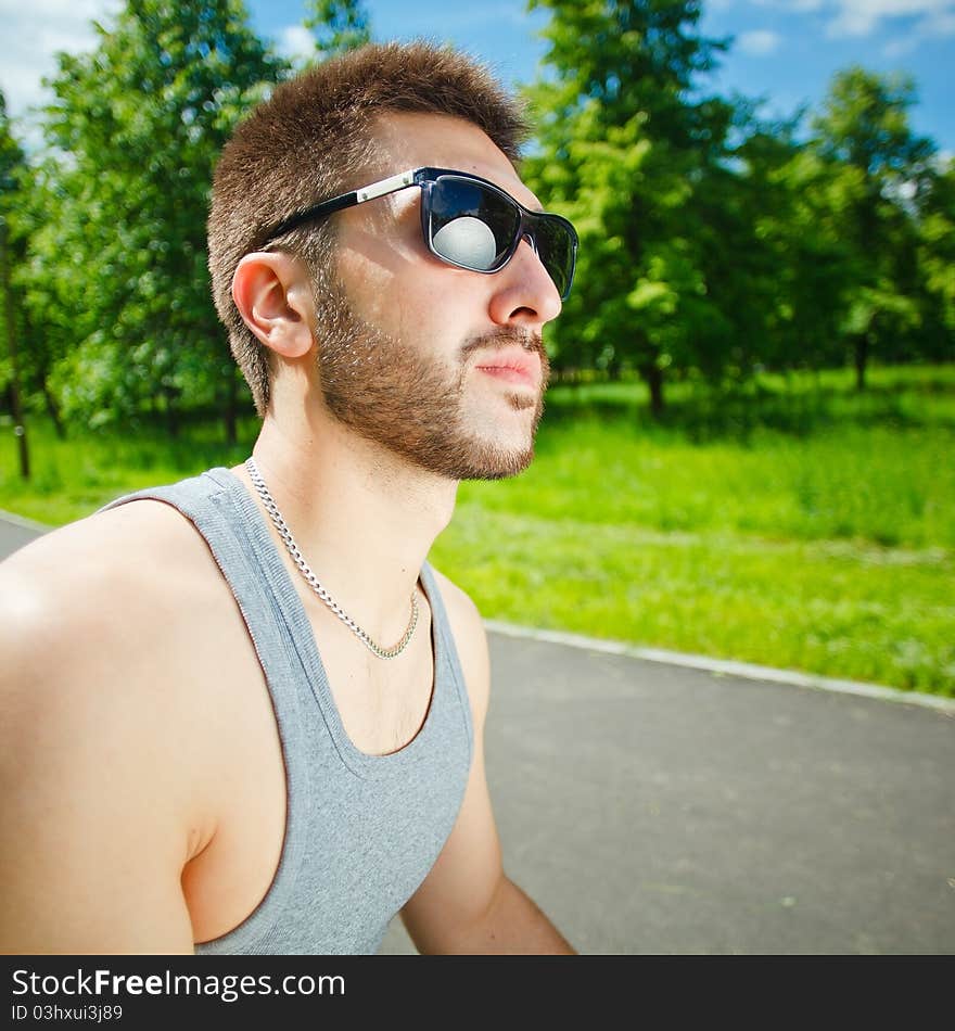 Young man in glasses on park. Young man in glasses on park