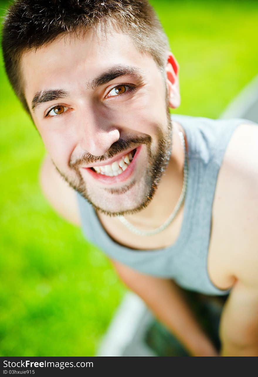 Young man smiling in park