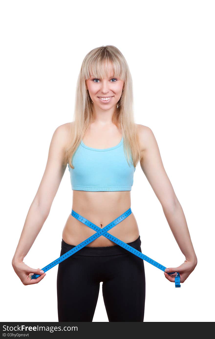 Attractive young and blond woman measuring size of her waist with a tape measure, smile, wear blue top. Vertical shot. Isolated on white background. Fitness concept. Attractive young and blond woman measuring size of her waist with a tape measure, smile, wear blue top. Vertical shot. Isolated on white background. Fitness concept.