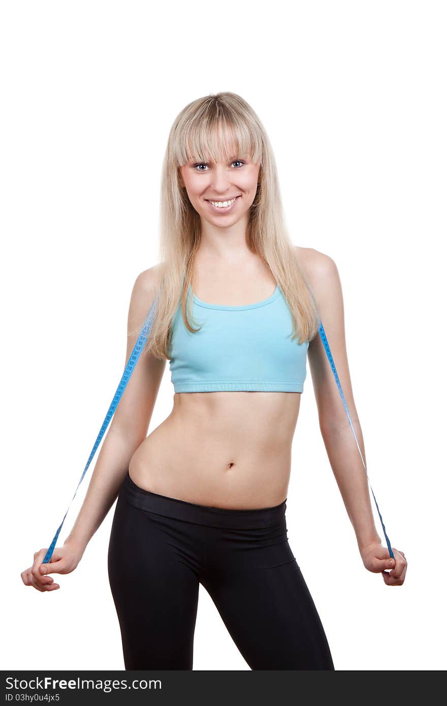 Attractive young and blond woman measuring size of her waist with a tape measure, smile, wear blue top. Vertical shot. Isolated on white background. Fitness concept. Attractive young and blond woman measuring size of her waist with a tape measure, smile, wear blue top. Vertical shot. Isolated on white background. Fitness concept.