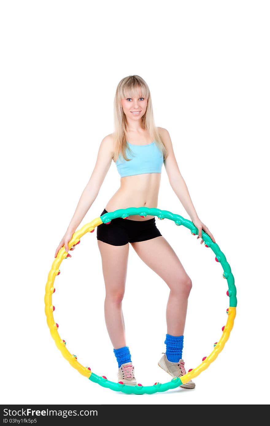 Young attractive woman holding hula hoop isolated over white background. Sport concept of girl exercising with hula hoop, twirling. Vertical shot. Young attractive woman holding hula hoop isolated over white background. Sport concept of girl exercising with hula hoop, twirling. Vertical shot.