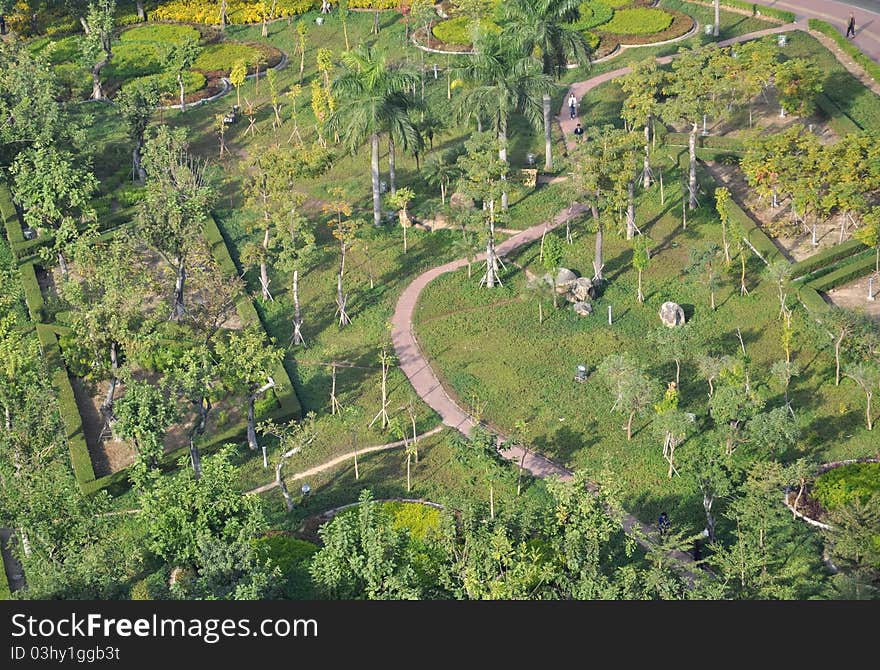 City garden with flourish trees,meadow,and a zigzag pavement footpath. City garden with flourish trees,meadow,and a zigzag pavement footpath.