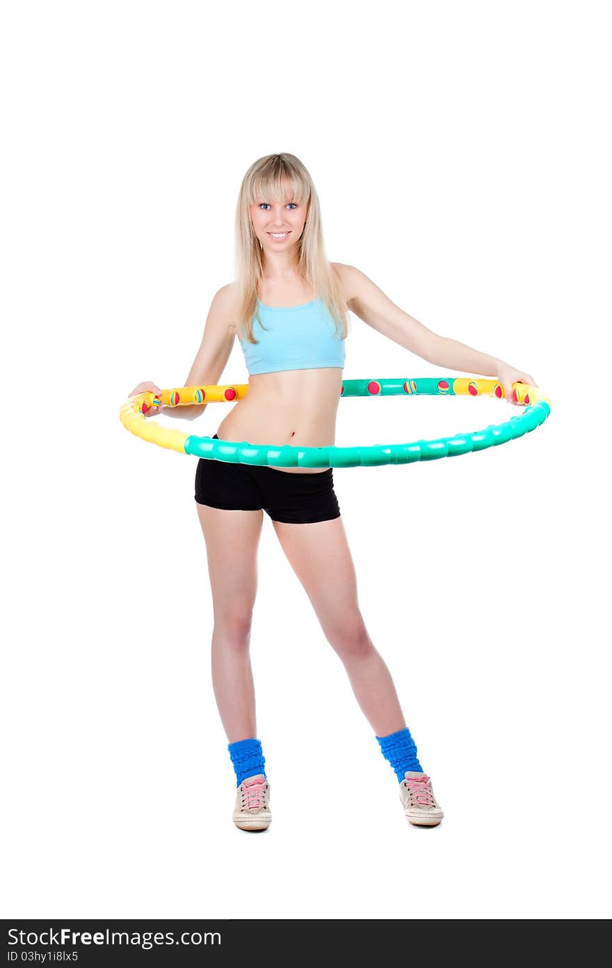 Young attractive woman holding hula hoop isolated over white background. Sport concept of girl exercising with hula hoop, twirling. Vertical shot. Young attractive woman holding hula hoop isolated over white background. Sport concept of girl exercising with hula hoop, twirling. Vertical shot.