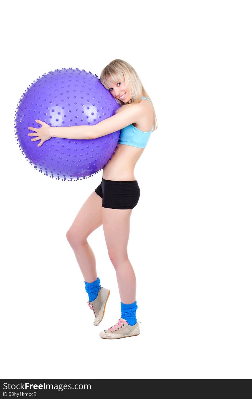 Young woman doing fitness exercise with a violet ball, smile. isolated over white background. Young woman doing fitness exercise with a violet ball, smile. isolated over white background.