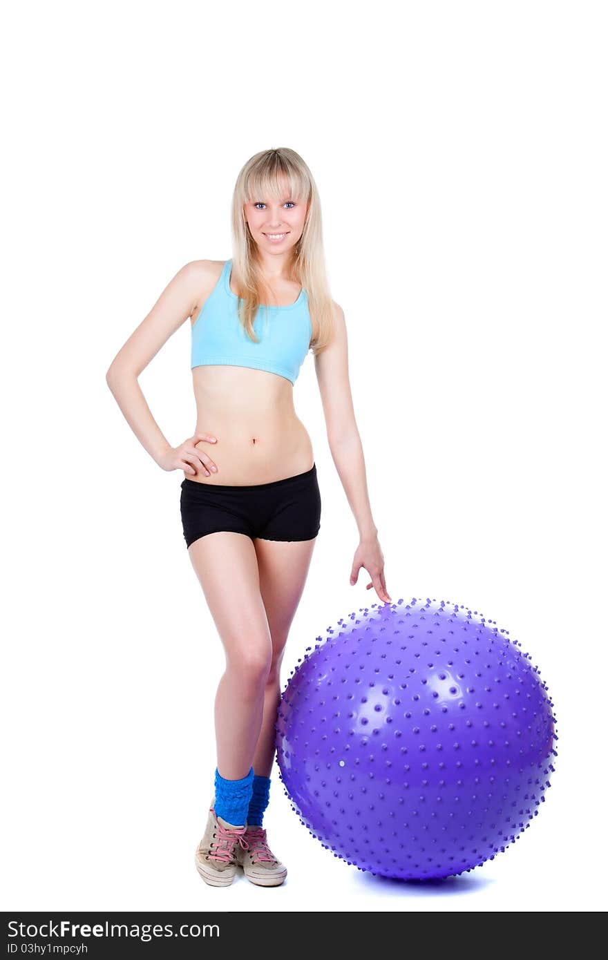 Young woman doing fitness exercise with a violet ball, smile. isolated over white background. Young woman doing fitness exercise with a violet ball, smile. isolated over white background.