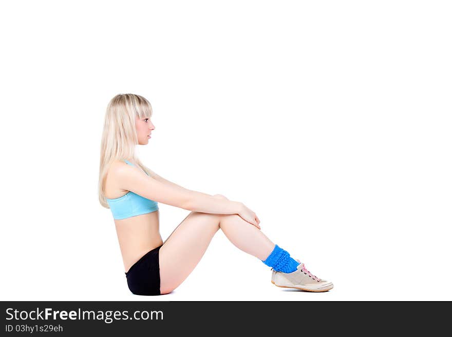 Pretty Fitness Young Lady Sitting On The Floor On Isolated White background Portrait of pretty young woman resting on fitness mat after exercising - Indoors. Pretty Fitness Young Lady Sitting On The Floor On Isolated White background Portrait of pretty young woman resting on fitness mat after exercising - Indoors