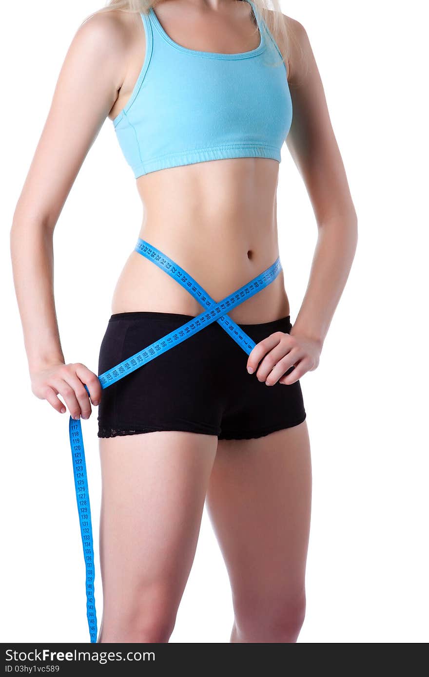 Attractive young athletic and woman measuring size of her waist with a tape measure, wear blue top. Vertical shot. Isolated on white background. Fitness concept. Attractive young athletic and woman measuring size of her waist with a tape measure, wear blue top. Vertical shot. Isolated on white background. Fitness concept.