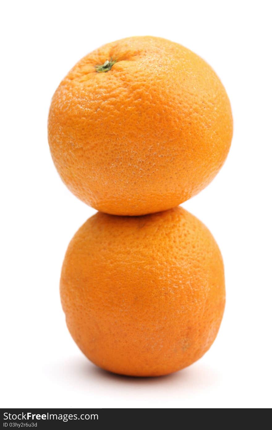 Two oranges stacked together isolated over white background.