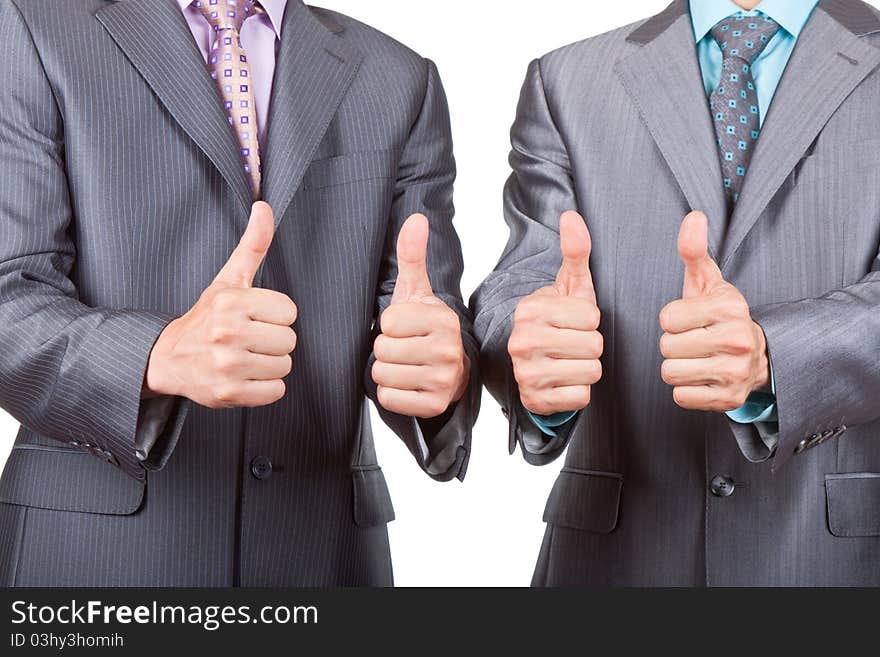 Two elegant businessmen standing and holding hands with thumbs up gesture, dressed in suit, shirt and tie. Concept Success, Approval, Good Work, isolated over white background. Two elegant businessmen standing and holding hands with thumbs up gesture, dressed in suit, shirt and tie. Concept Success, Approval, Good Work, isolated over white background.