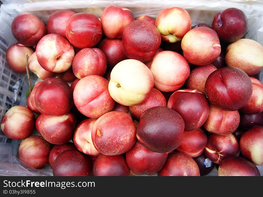 Bright red peach, is mature, and very sweet crisp. Put in the market for sale.