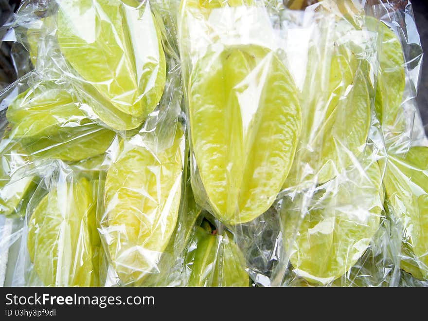 Carambola, by transparent plastic bag, sold on the market.