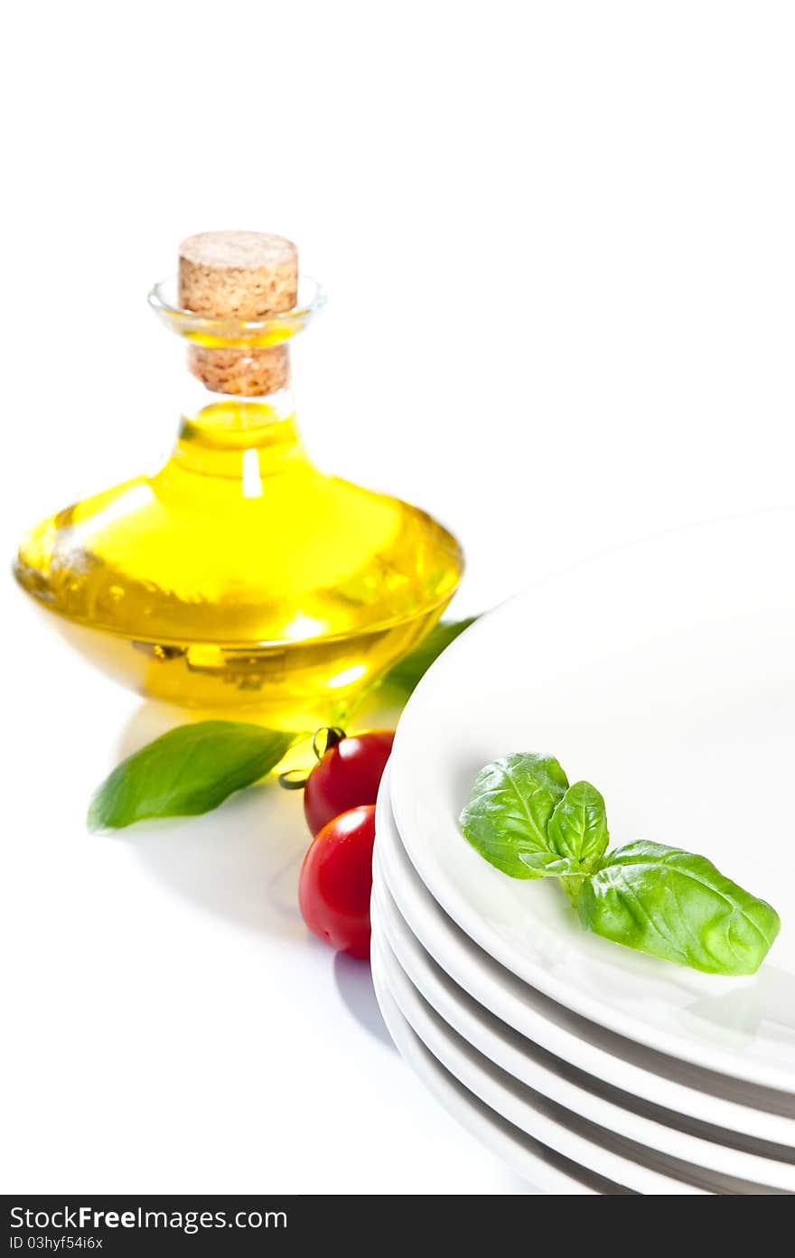 Plate decorated with basil and tomato