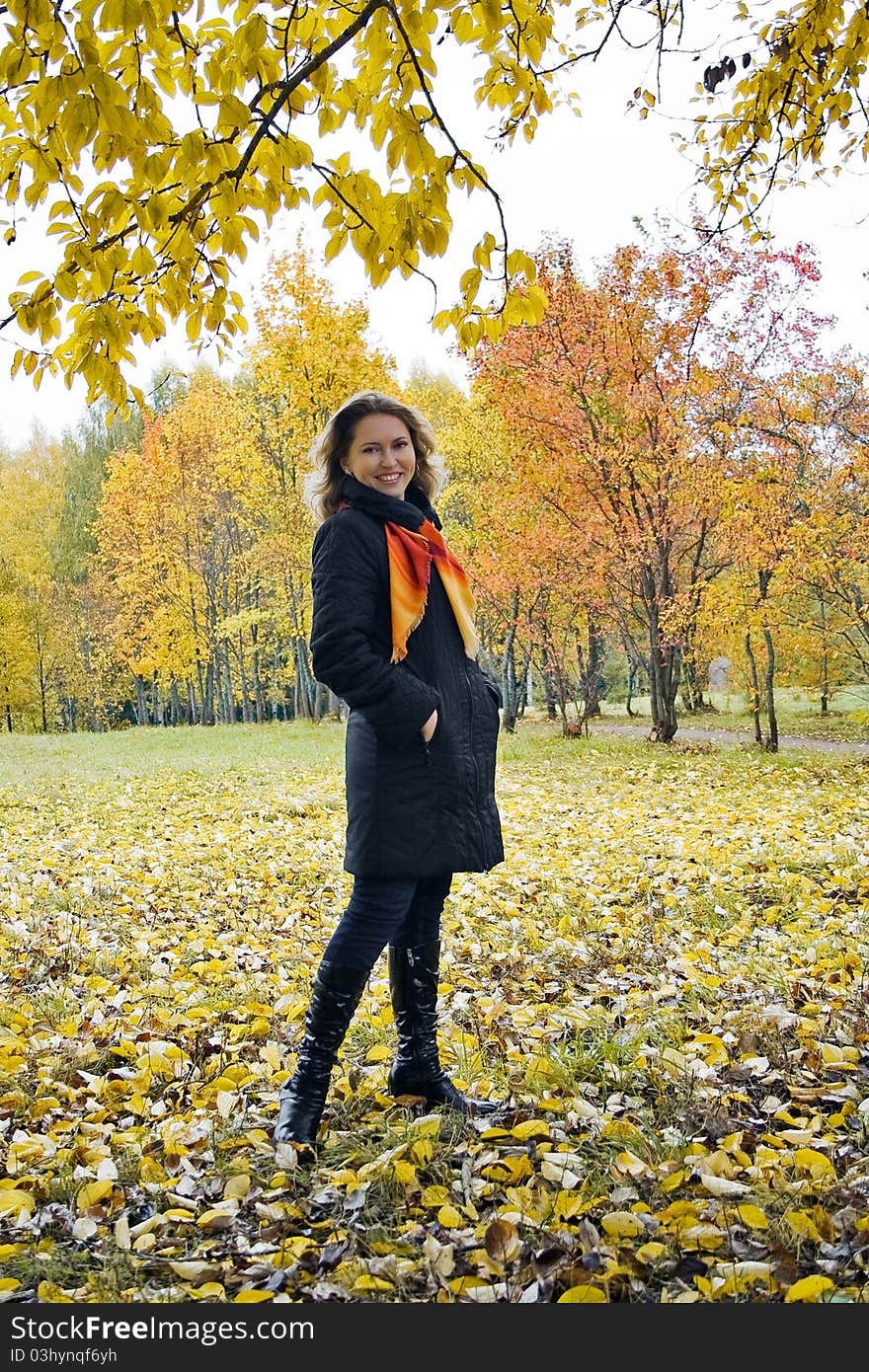 Pretty woman standing in autumn park. Pretty woman standing in autumn park