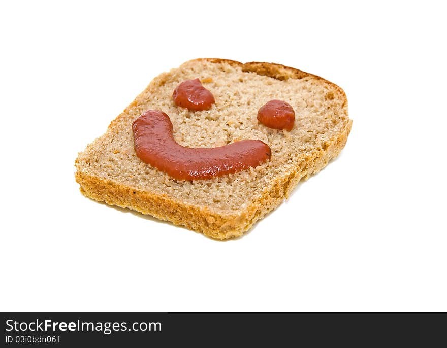 Smiley face on a piece of black bread isolated on white background