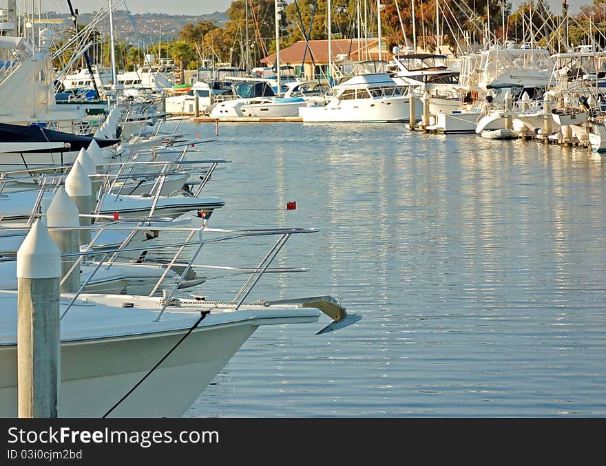 Watercraft Docked in a Row at a Marina. Watercraft Docked in a Row at a Marina.