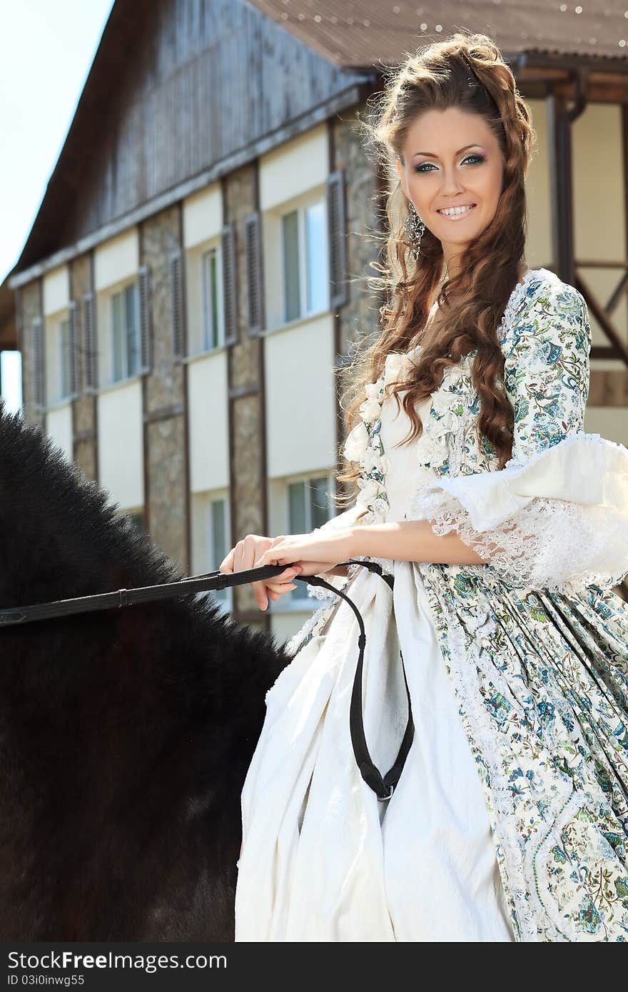 Beautiful young woman in medieval dress with a horse outdoor. Beautiful young woman in medieval dress with a horse outdoor.