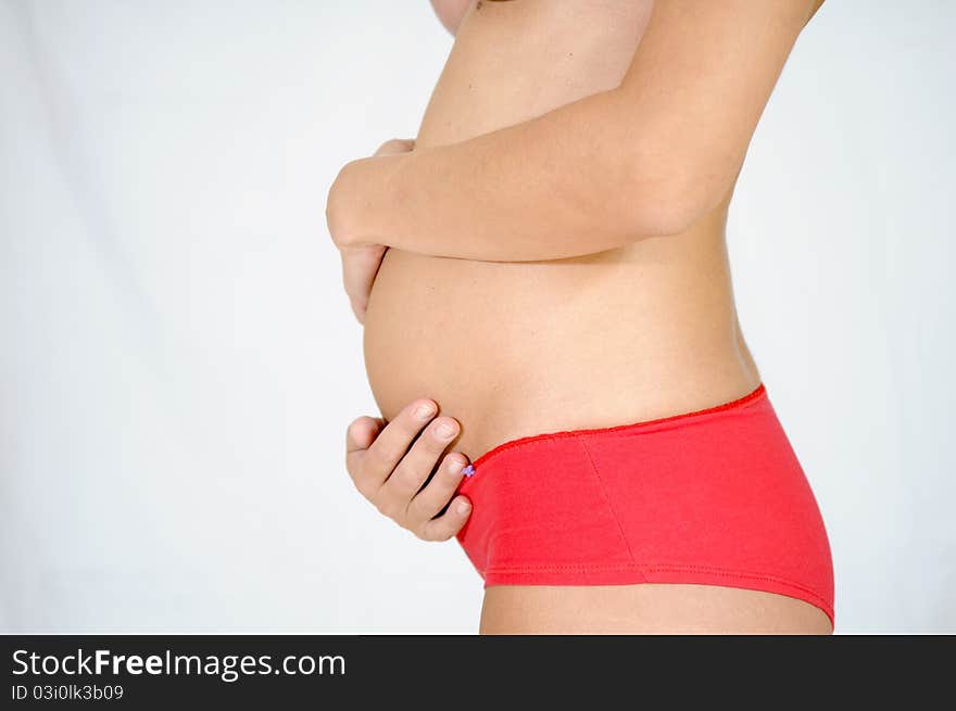 Five-month pregnant woman with red panties. Five-month pregnant woman with red panties