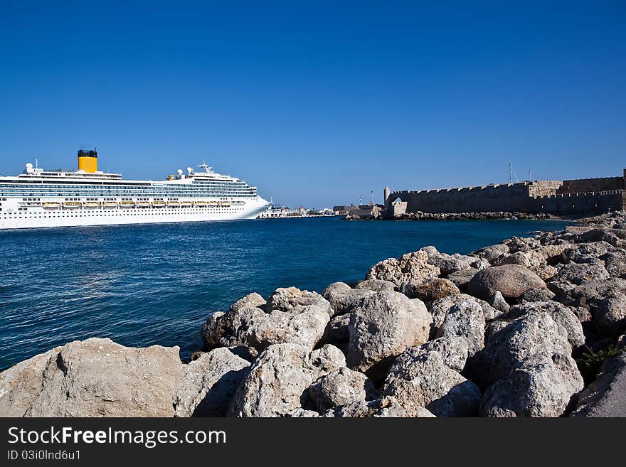 Large cruiser sailing outside Rhodes island in Greece at summer time. Large cruiser sailing outside Rhodes island in Greece at summer time