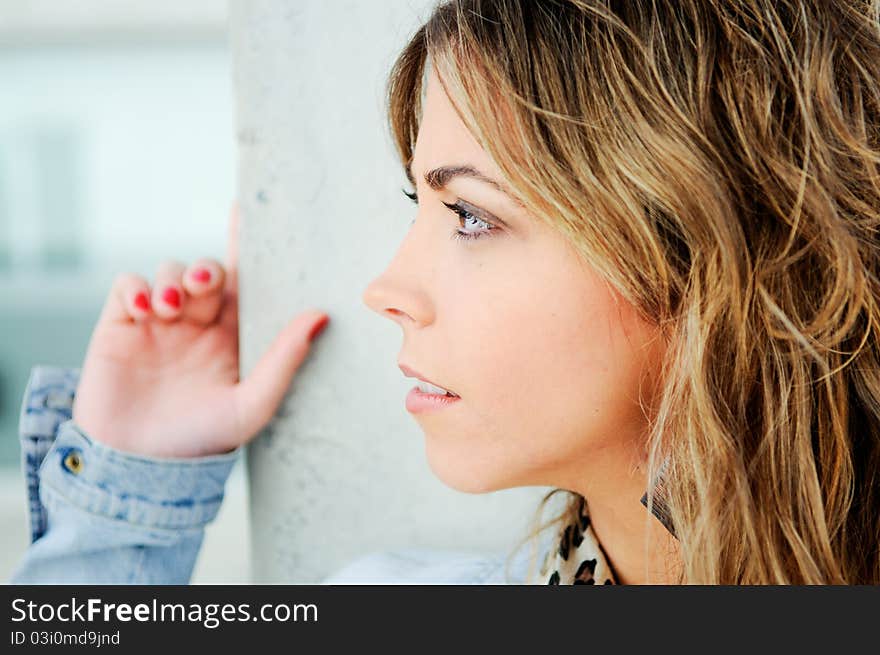 A close up portrait of a pretty blonde girl profile