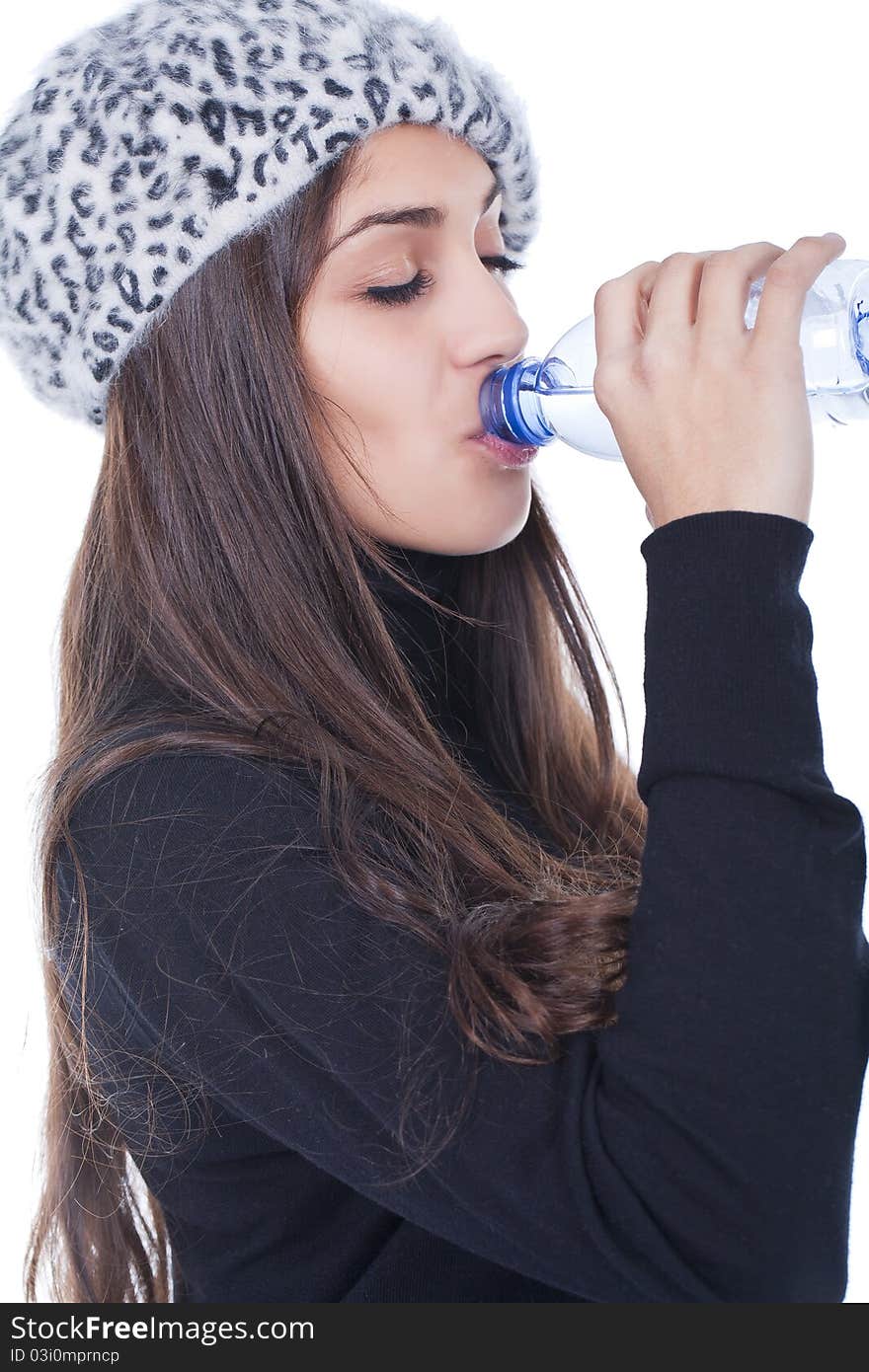 Beautiful woman holding a bottle and  drinking water. Beautiful woman holding a bottle and  drinking water