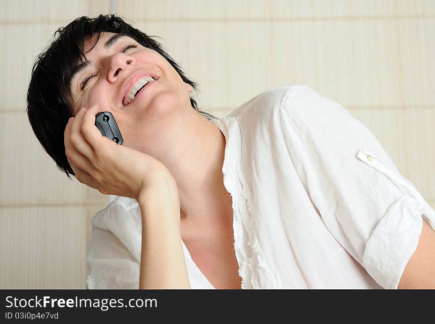 Women talking and laughing in a telephone conversation. Women talking and laughing in a telephone conversation