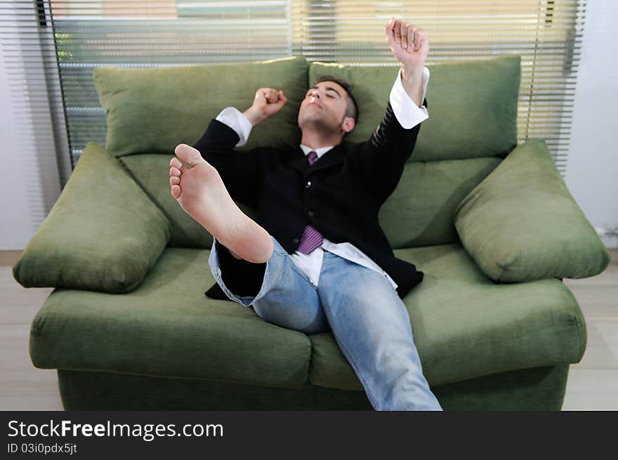 A barefoot young man in a suit, holding a victory. A barefoot young man in a suit, holding a victory