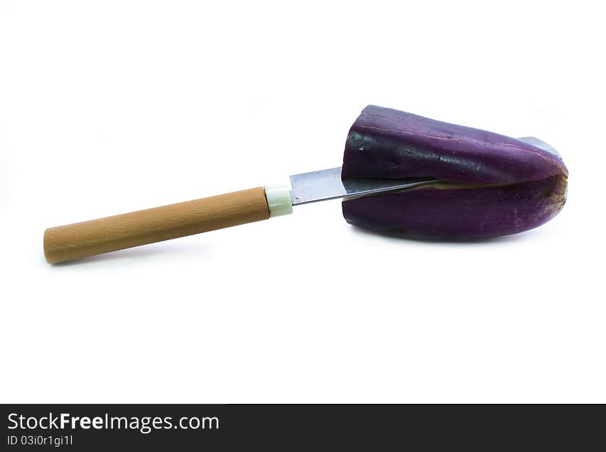 Fresh raw eggplant sliced with a knife. Fresh raw eggplant sliced with a knife.