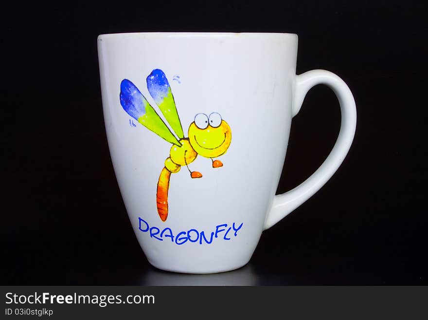 Coffee cup and dragonfly