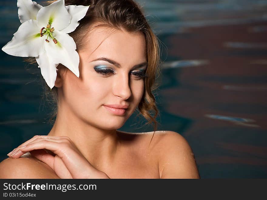 Portrait of young girl with flower in water