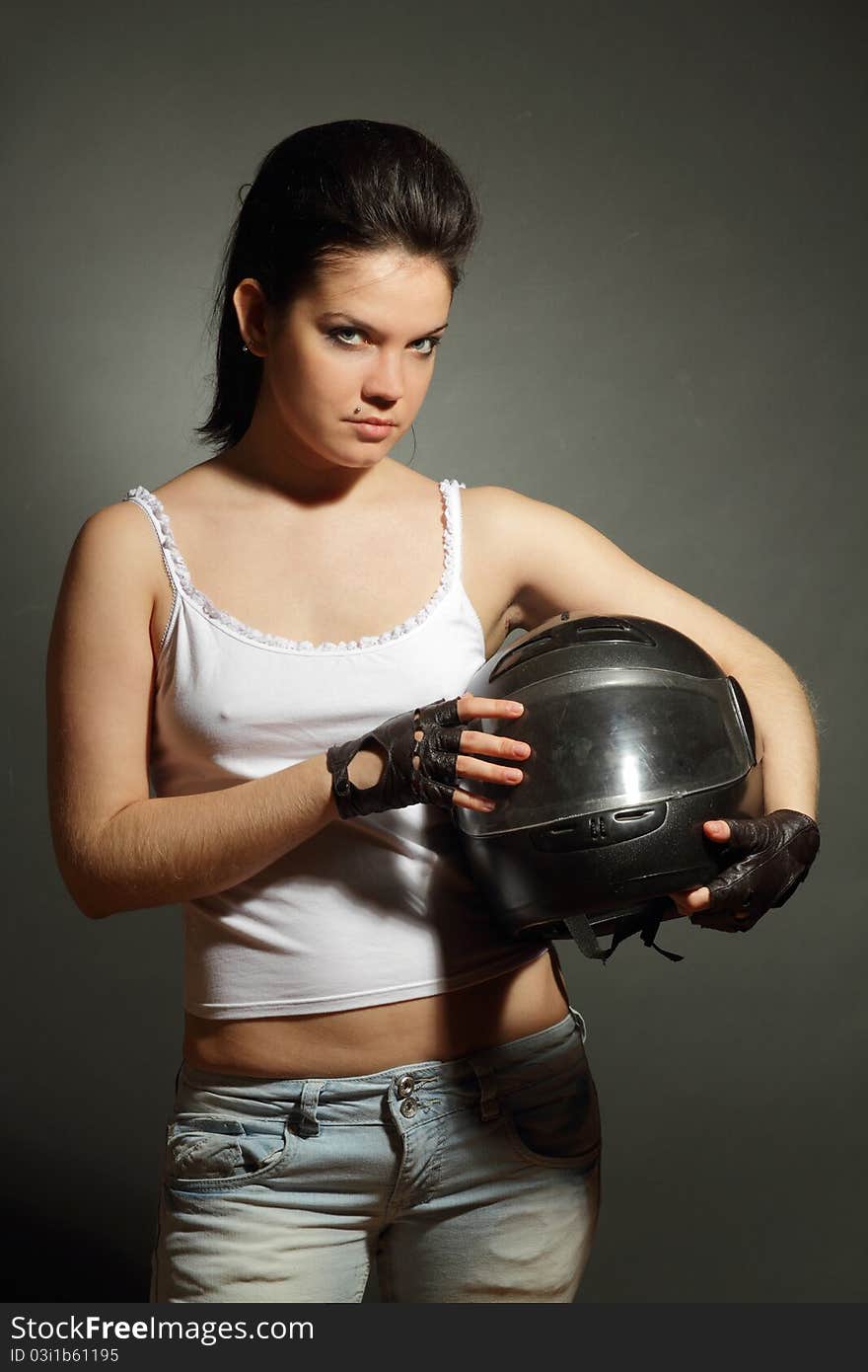 The girl with a motorcycle helmet on a gray background