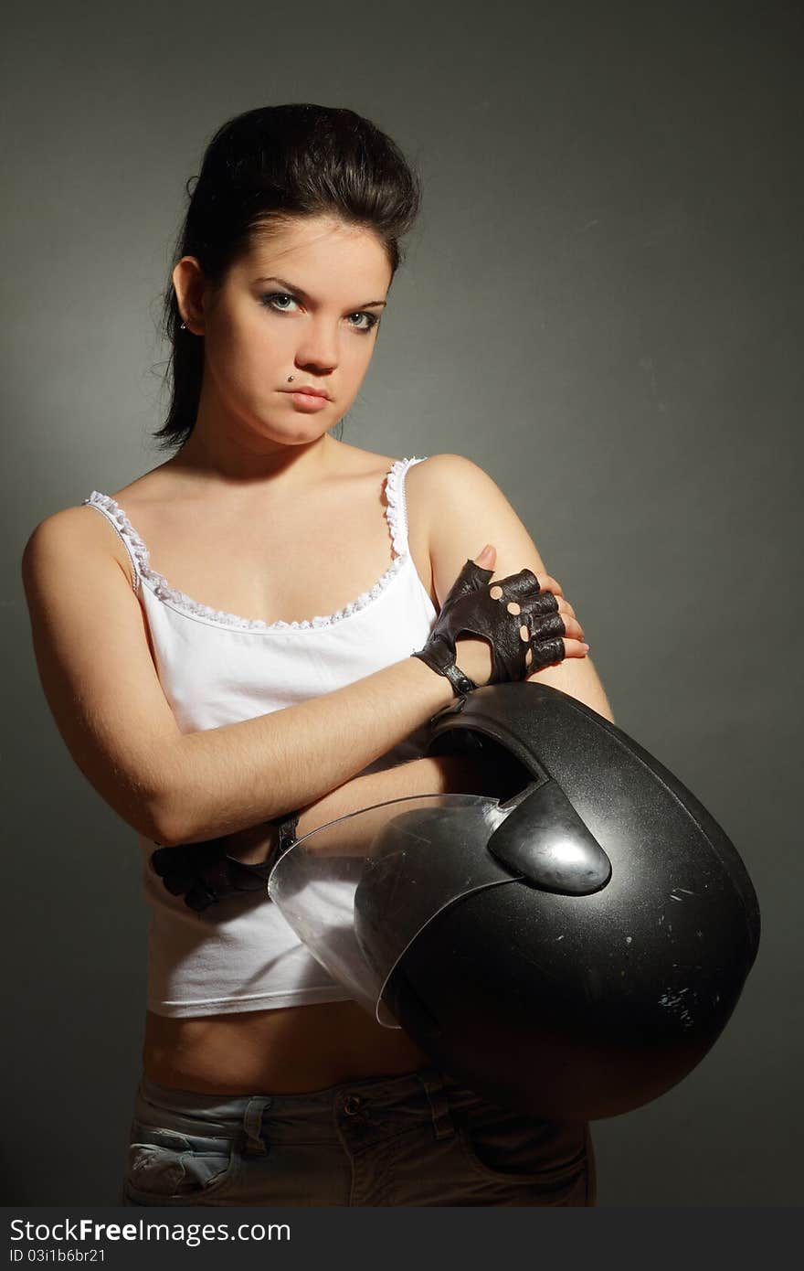 The girl with a motorcycle helmet on a gray background