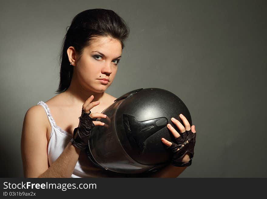 The girl with a motorcycle helmet on a gray background