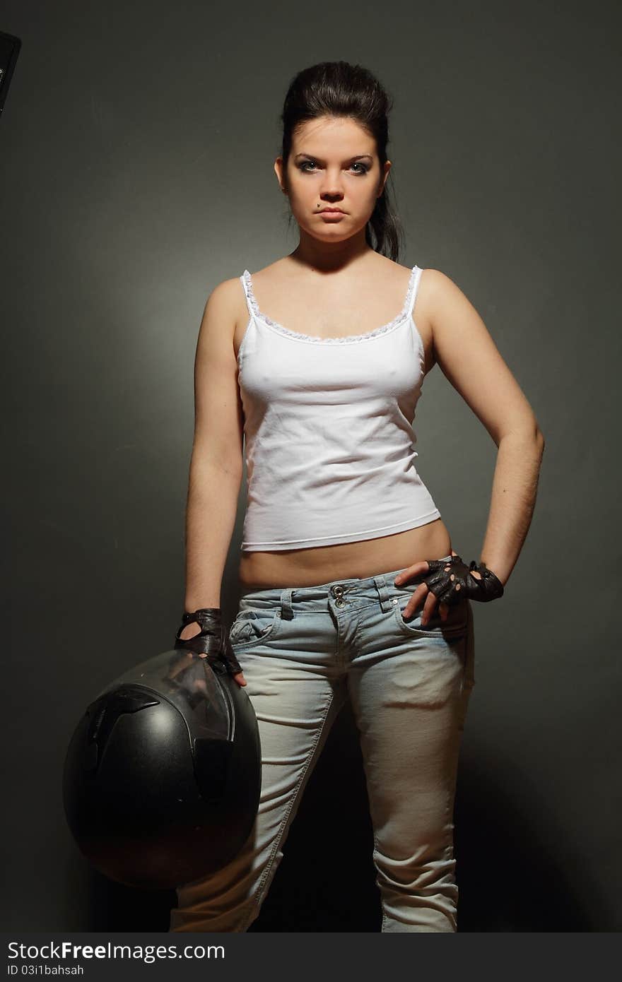 The girl with a motorcycle helmet on a gray background