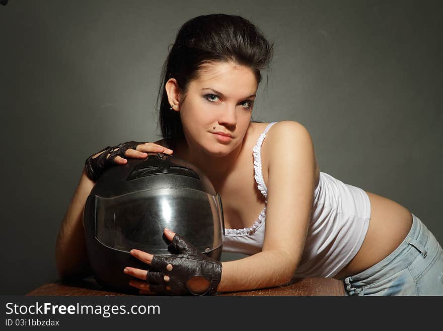 The girl with a motorcycle helmet on a gray background