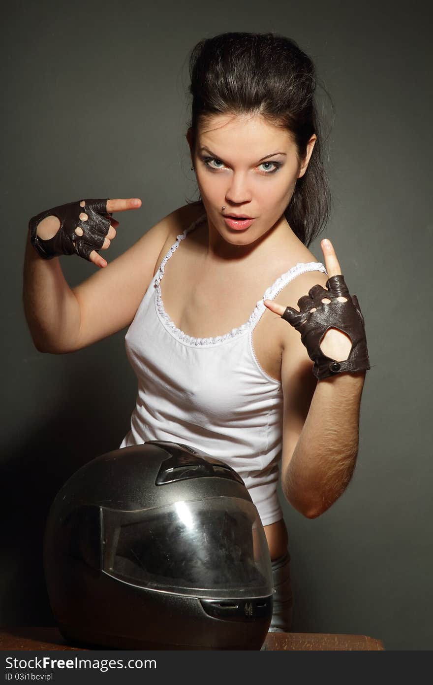 The girl with a motorcycle helmet on a gray background