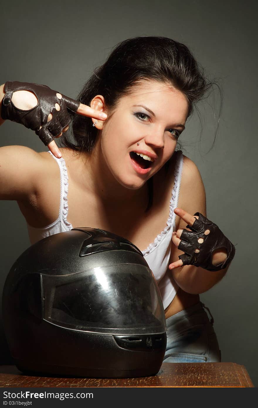 The girl with a motorcycle helmet on a gray background