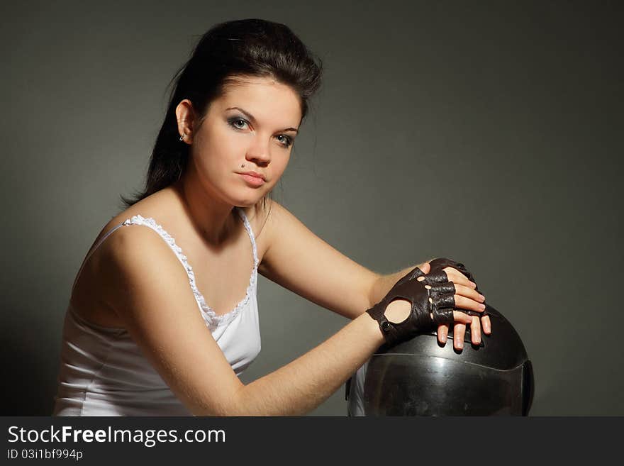 The girl with a motorcycle helmet on a gray background