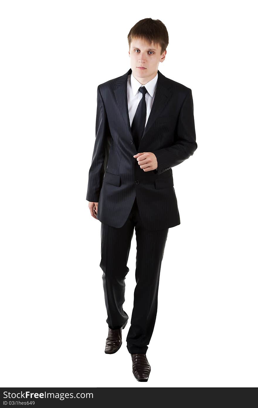 Young business man seriously walk forward on white background