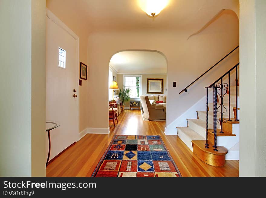 Hallway With Large Staircase And Dinign Room